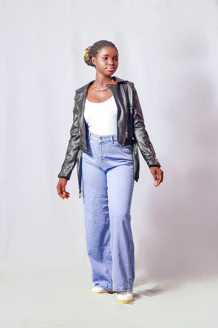Crafting Captivating Headlines: Your awesome post title goes here Stylish young woman in denim and leather jacket posing in studio setting.